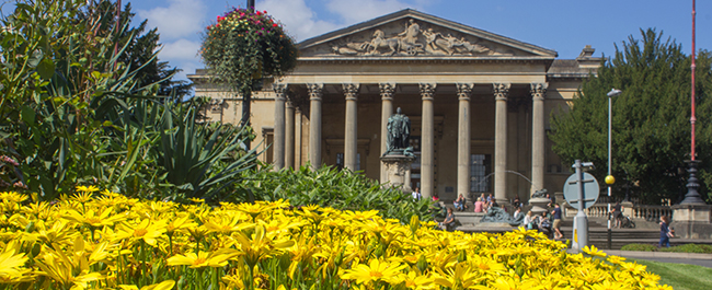 Image of the Victoria Rooms with flowers in the foreground